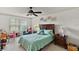 Bright bedroom with a queen bed, dresser and ceiling fan at 22777 Sw Surf Blvd, Dunnellon, FL 34431