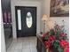 Welcoming home foyer with an elegant door, tiled floor, and stylish decor at 22777 Sw Surf Blvd, Dunnellon, FL 34431