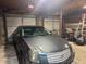 Garage featuring a gray car and multiple garage doors at 22777 Sw Surf Blvd, Dunnellon, FL 34431