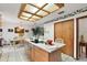 Open kitchen with island, dining area, and views to Gathering room at 22777 Sw Surf Blvd, Dunnellon, FL 34431