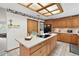 Kitchen features an island, wood cabinets, and a breakfast bar at 22777 Sw Surf Blvd, Dunnellon, FL 34431