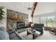 Living room with stone fireplace, two sofas, and a rocking chair at 22777 Sw Surf Blvd, Dunnellon, FL 34431