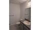 Simple bathroom with gray vanity and tile flooring at 24162 Nw Hemlock Ave, Dunnellon, FL 34431
