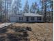 Newly constructed home with a well-maintained lawn at 24162 Nw Hemlock Ave, Dunnellon, FL 34431