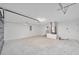 Unfinished garage with concrete floor and door at 24300 Sw Sea Cliff Ave, Dunnellon, FL 34431