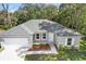 Single-story house with gray roof, white garage door, and landscaped front at 281 Marion Oaks Crse, Ocala, FL 34473