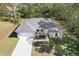 Single-story house with gray roof, white garage door, and landscaping at 281 Marion Oaks Crse, Ocala, FL 34473