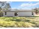 House exterior showcasing a grassy backyard at 281 Marion Oaks Crse, Ocala, FL 34473