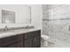 Bathroom with granite double vanity, large mirror, and walk-in shower at 281 Marion Oaks Crse, Ocala, FL 34473