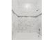 Clean bathroom with white tub and marble tile at 281 Marion Oaks Crse, Ocala, FL 34473
