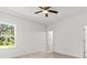 Spacious bedroom with ceiling fan and large window offering natural light at 281 Marion Oaks Crse, Ocala, FL 34473