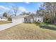 New single-story house with gray siding, white garage door, and green lawn at 281 Marion Oaks Crse, Ocala, FL 34473