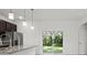 Kitchen with granite countertops, dark cabinets, and sliding door to backyard at 281 Marion Oaks Crse, Ocala, FL 34473