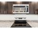 Stainless steel stove top and microwave in a contemporary kitchen setting at 281 Marion Oaks Crse, Ocala, FL 34473
