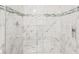 Modern shower with marble-tiled walls and glass enclosure at 281 Marion Oaks Crse, Ocala, FL 34473