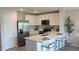 Modern kitchen with white cabinets, stainless steel appliances, and an island at 3300 Bertram Rd, Wildwood, FL 34785