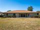 House back view, showcasing a large backyard and patio at 3333 Nw 47Th Ct, Ocala, FL 34482