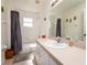 Clean bathroom with a single vanity and bathtub shower combo at 3333 Nw 47Th Ct, Ocala, FL 34482