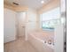 Main bathroom with a large bathtub and a window at 3333 Nw 47Th Ct, Ocala, FL 34482