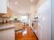 Galley kitchen with light wood cabinets and modern appliances at 3333 Nw 47Th Ct, Ocala, FL 34482
