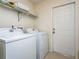 Bright laundry room, washer, dryer, and storage shelves at 3333 Nw 47Th Ct, Ocala, FL 34482