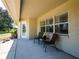 Covered patio with seating area and sliding glass door at 3333 Nw 47Th Ct, Ocala, FL 34482