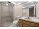 Bathroom with a shower, a toilet and a sink with a big mirror at 3856 Ne 19Th Street Cir, Ocala, FL 34470
