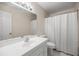 Bathroom with a sink, toilet, big mirror and bath tub with a shower curtain at 3856 Ne 19Th Street Cir, Ocala, FL 34470