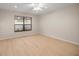 Bedroom with a window, ceiling fan and light wood floor at 3856 Ne 19Th Street Cir, Ocala, FL 34470