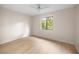 Bedroom with a window, ceiling fan and light wood floor at 3856 Ne 19Th Street Cir, Ocala, FL 34470