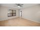 Bright bedroom features a ceiling fan and a big window at 3856 Ne 19Th Street Cir, Ocala, FL 34470