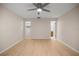 Bright bedroom features a ceiling fan, closet, and an en-suite bathroom at 3856 Ne 19Th Street Cir, Ocala, FL 34470