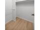 Walk-in closet with rod and light wood floor at 3856 Ne 19Th Street Cir, Ocala, FL 34470
