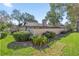 Exterior view of a single story townhome with lush landscaping and a well-maintained lawn at 3856 Ne 19Th Street Cir, Ocala, FL 34470