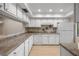 Well-lit kitchen boasts white cabinets, granite countertops, and modern stainless-steel appliances at 3856 Ne 19Th Street Cir, Ocala, FL 34470