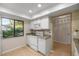 Well-lit kitchen features white appliances, granite countertops, and a window with lush greenery views at 3856 Ne 19Th Street Cir, Ocala, FL 34470