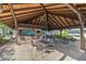 Outdoor covered bar and seating area with a high ceiling, perfect for entertaining poolside at 3856 Ne 19Th Street Cir, Ocala, FL 34470