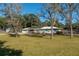 Light green home with solar panels and a large backyard at 4005 Sw 183Rd Ter, Dunnellon, FL 34432