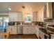 Kitchen with white cabinets, granite countertops and view to backyard at 4005 Sw 183Rd Ter, Dunnellon, FL 34432