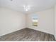 Bright bedroom with wood-look floors and a window at 4069 Sw 130Th Pl, Ocala, FL 34473