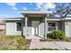 House entrance with a white door and a covered porch at 4069 Sw 130Th Pl, Ocala, FL 34473