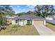 Charming single-story home featuring an attached two-car garage and well-maintained lawn at 4069 Sw 130Th Pl, Ocala, FL 34473