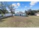 House rear view, showcasing a sliding glass door and yard at 4069 Sw 130Th Pl, Ocala, FL 34473
