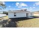 House rear view, showcasing a sliding glass door and yard at 4069 Sw 130Th Pl, Ocala, FL 34473