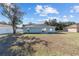 House rear view, showcasing a sliding glass door and yard at 4069 Sw 130Th Pl, Ocala, FL 34473