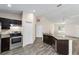 Modern kitchen with stainless steel appliances and dark cabinetry at 4069 Sw 130Th Pl, Ocala, FL 34473