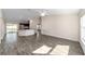 Spacious living room with wood-look floors and an open kitchen at 4069 Sw 130Th Pl, Ocala, FL 34473
