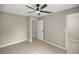 Spacious bedroom with ceiling fan and access to bathroom at 4677 Sw 166Th Loop, Ocala, FL 34473