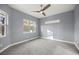 Bright bedroom featuring a large window and ceiling fan at 4892 Nw 101St Street Rd, Ocala, FL 34482