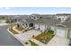 Two-story house with a front porch, two-car garage, and landscaped yard; aerial view at 6115 Sw 74Th Ct, Ocala, FL 34474